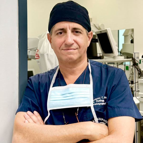 Portrait of a female healthcare worker in scrubs, arms crossed, confident expression.
