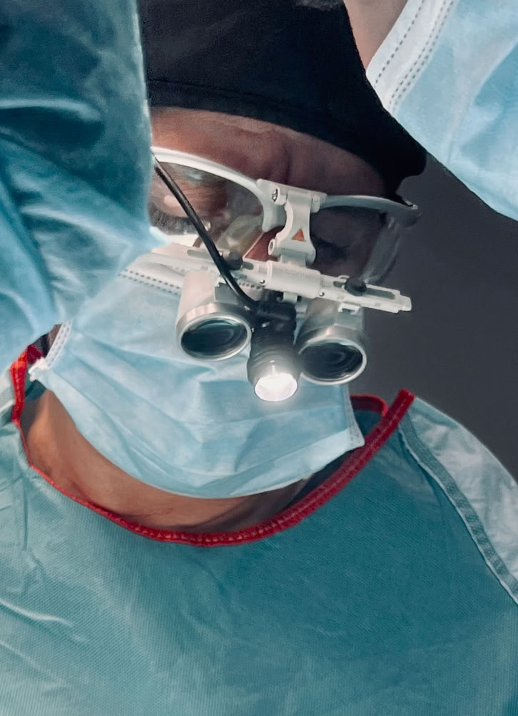 A plastic surgeon examines a patient's nose in a modern clinic setting in Istanbul.