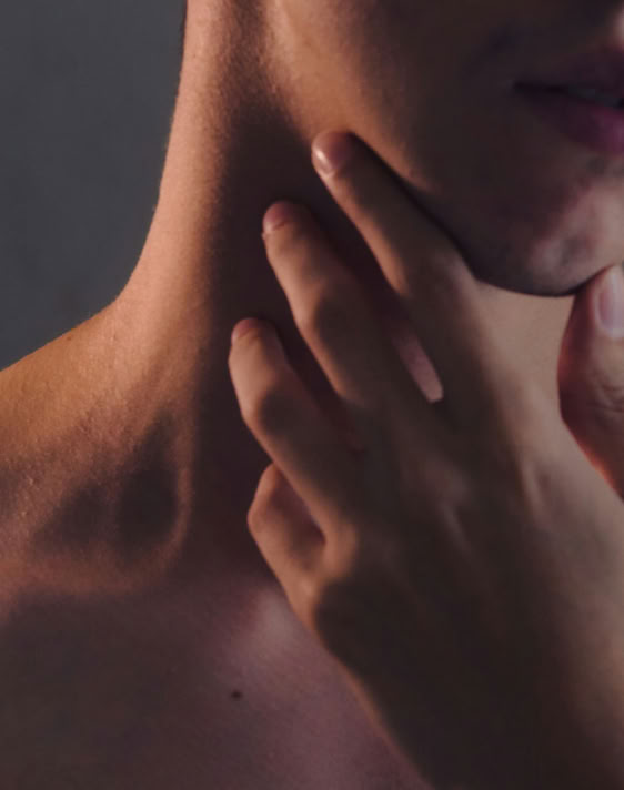 Close-up of a young tabby kitten with striking blue eyes and a playful expression.